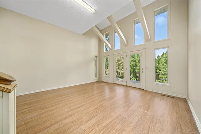 a view of empty room with wooden floor