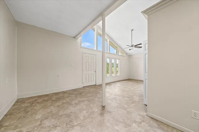 a view of a livingroom with a ceiling fan and window