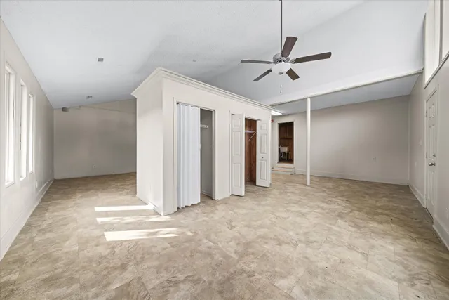 a view of empty room with ceiling fan