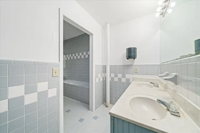 a view of an empty room with cabinet and a window