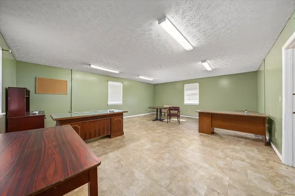 a view of an empty room with closet and window