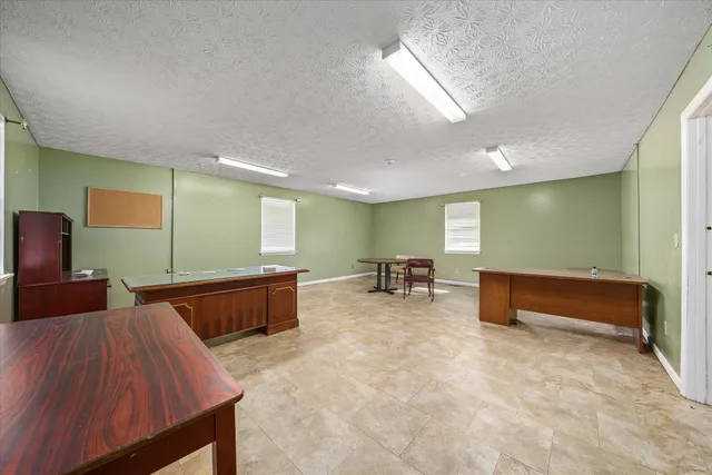 a view of an empty room with closet and window