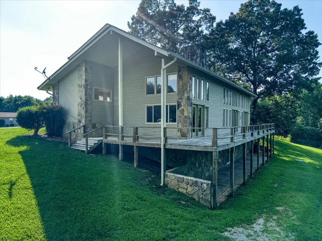 a view of a big yard with large trees