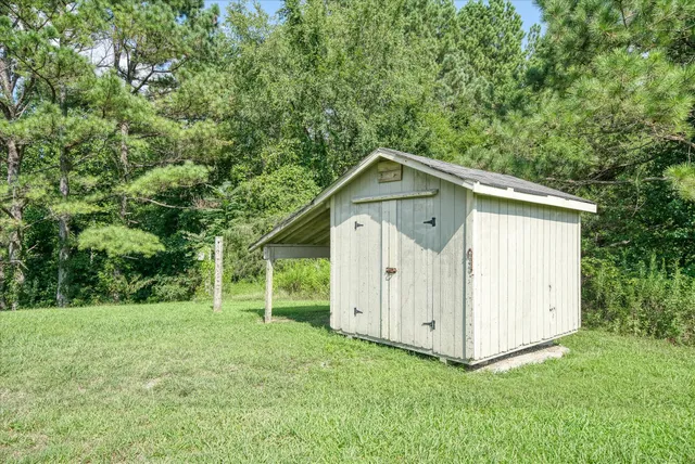 a view of a field with trees in the background