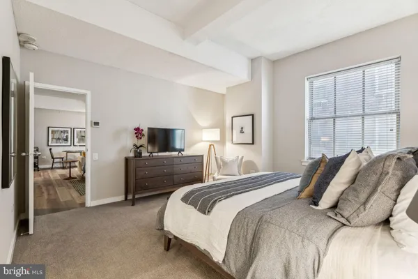a bedroom with a bed and a flat screen tv