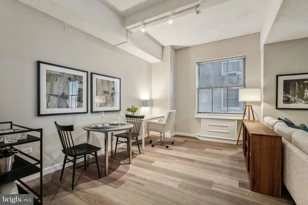 a view of a dining room with furniture window and wooden floor