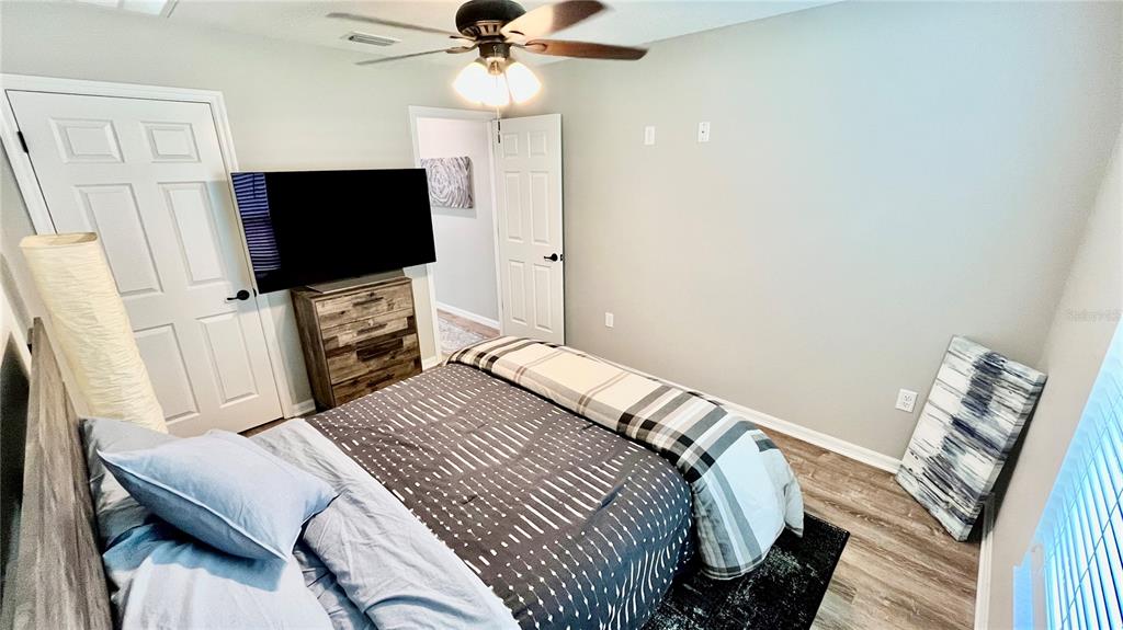 13486 English Sparrow Road Weeki Wachee, FL 34614 - Photo 32 of 51 a bedroom with a bed and a flat screen tv