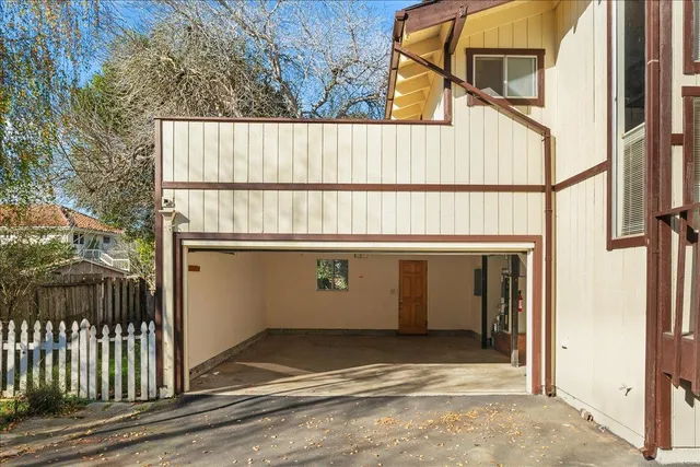 an aerial view of a city with lots of residential buildings and ocean view in back
