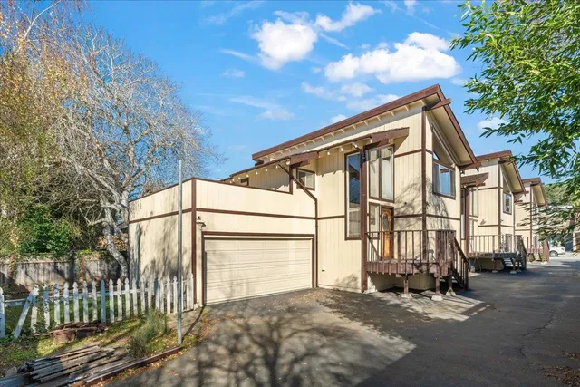 a view of a street with house in the background