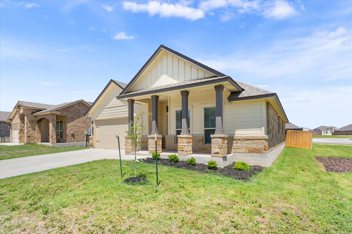 5830 Copano Road Belton, TX 76513 - Photo 4 of 34 Craftsman house with concrete driveway, board and batten siding, stone siding, a front yard, and a porch