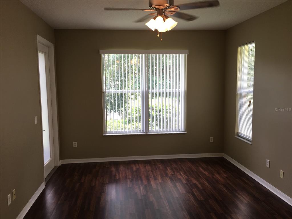 18047 Java Isle Drive Tampa, FL 33647 - Photo 7 of 21 a view of an empty room with wooden floor and a window