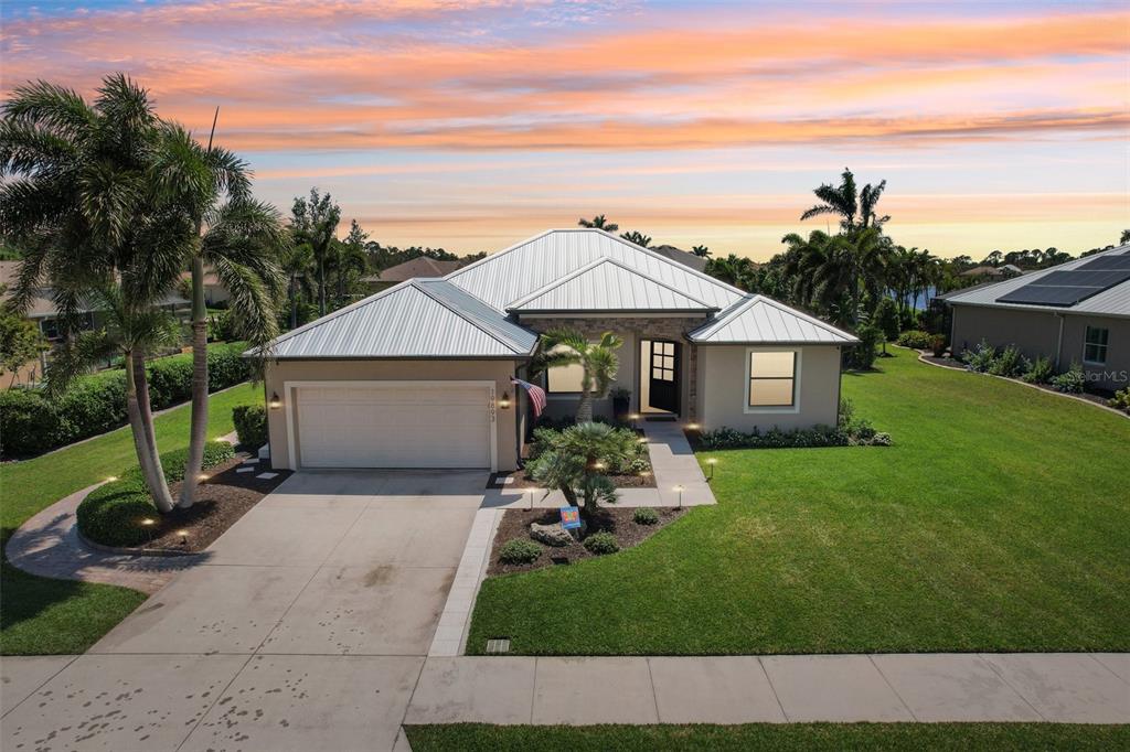 a front view of a house with a garden and yard