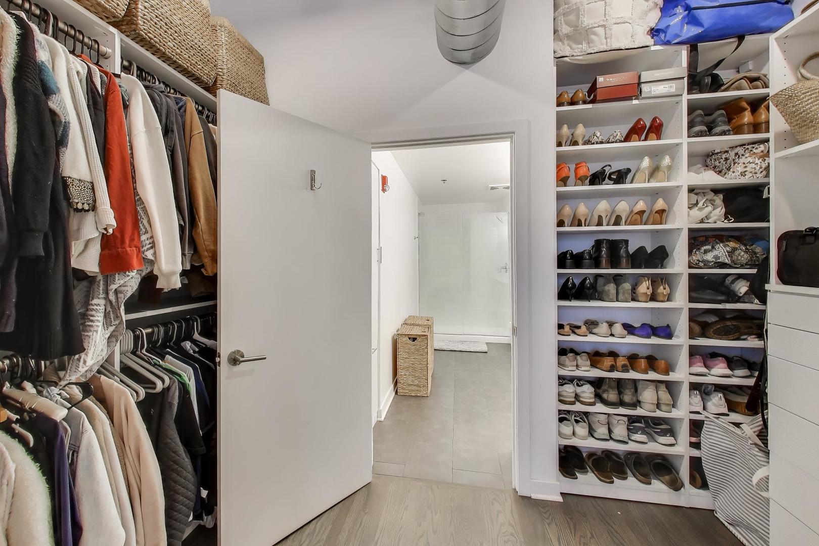 933 West Van Buren Street, Unit 504 Chicago, IL 60607 - Photo 17 of 31 a view of walk in closet with clothes and shoes