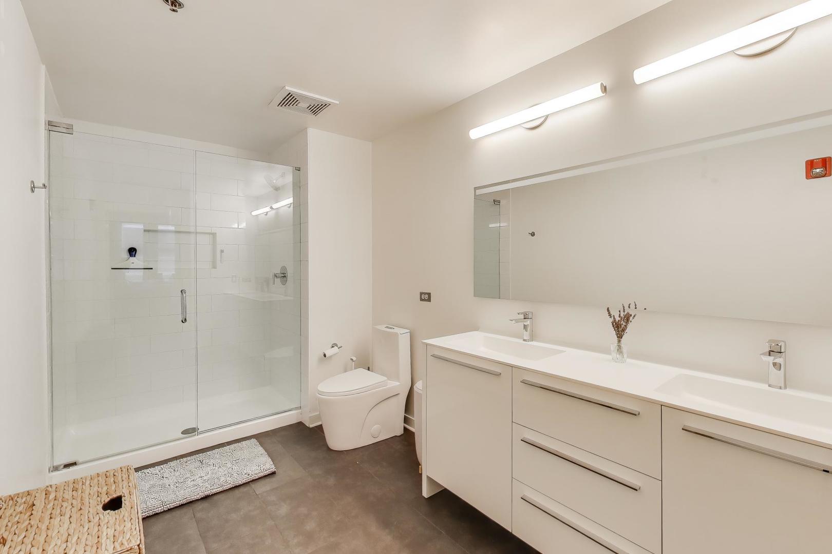 933 West Van Buren Street, Unit 504 Chicago, IL 60607 - Photo 18 of 31 a bathroom with a toilet sink and shower