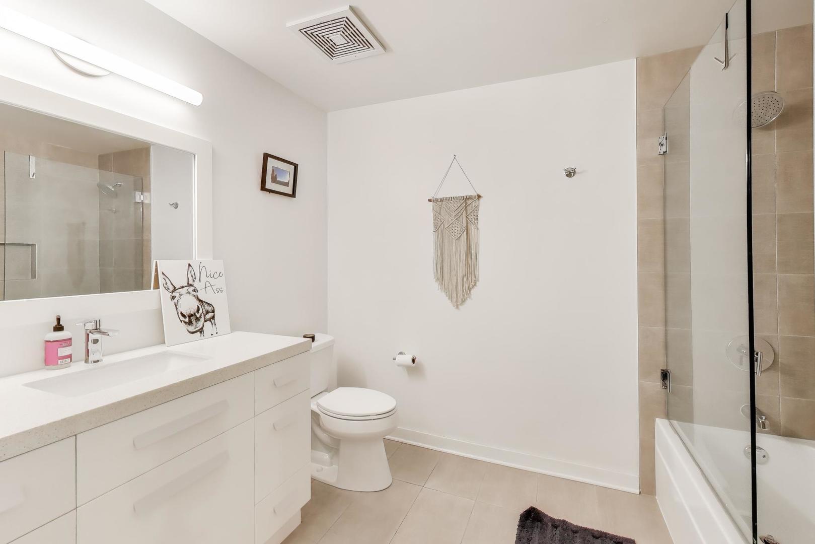 933 West Van Buren Street, Unit 504 Chicago, IL 60607 - Photo 21 of 31 a white toilet sitting next to a bathroom sink