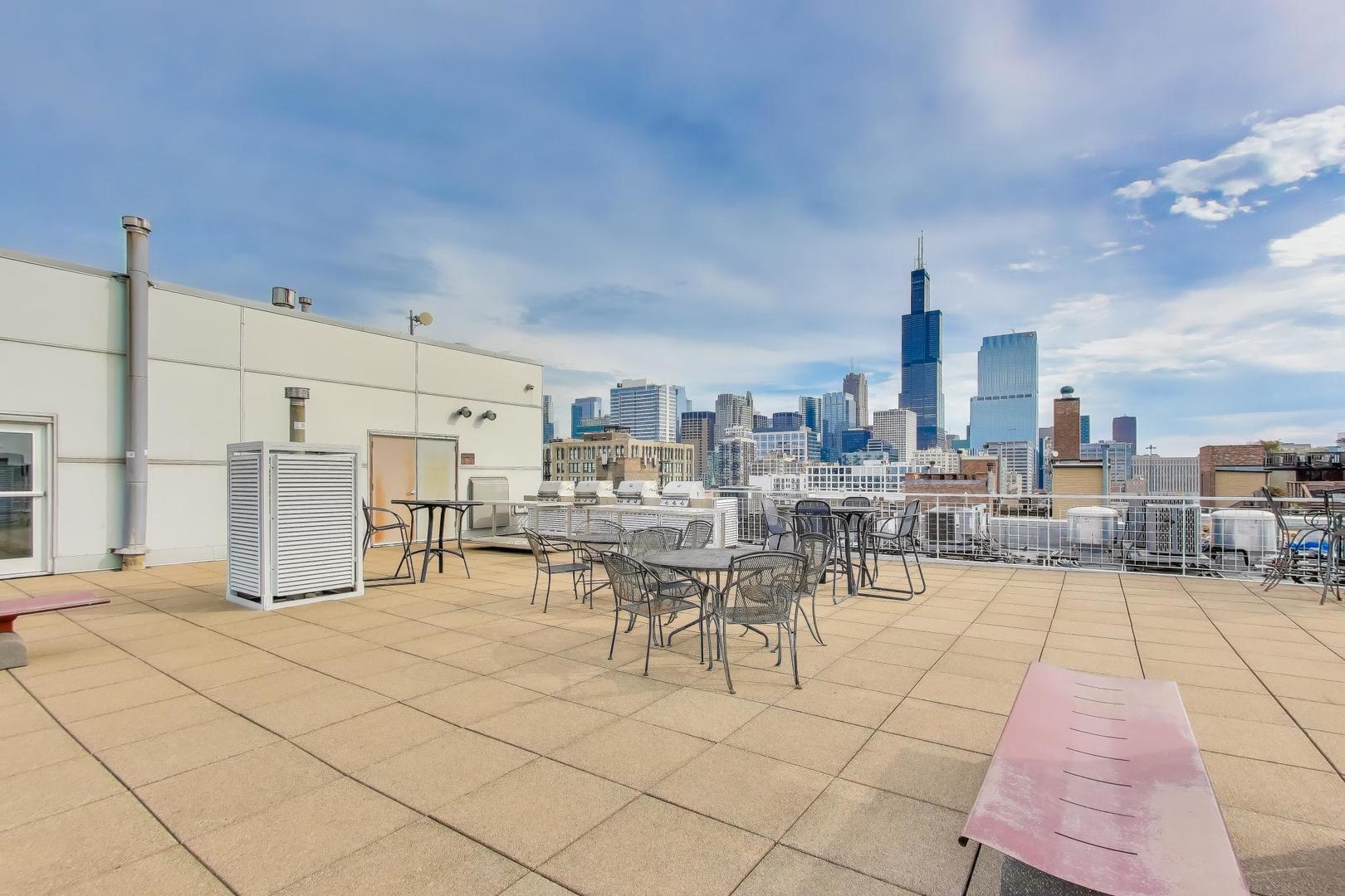 933 West Van Buren Street, Unit 504 Chicago, IL 60607 - Photo 29 of 31 a view of a patio with dining table and chairs
