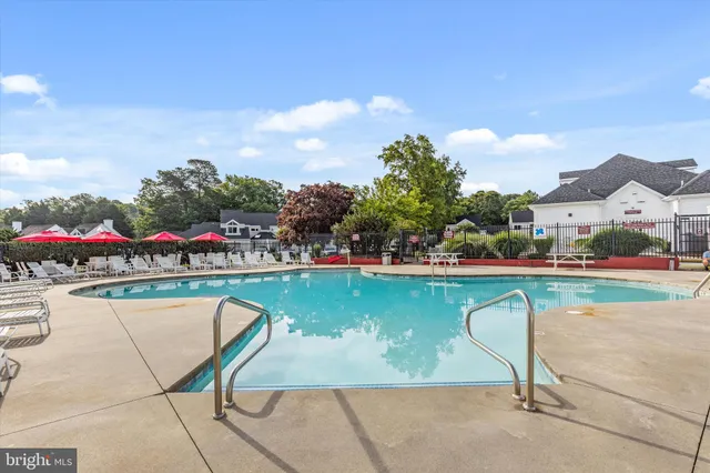 a view of swimming pool with outdoor seating and city view