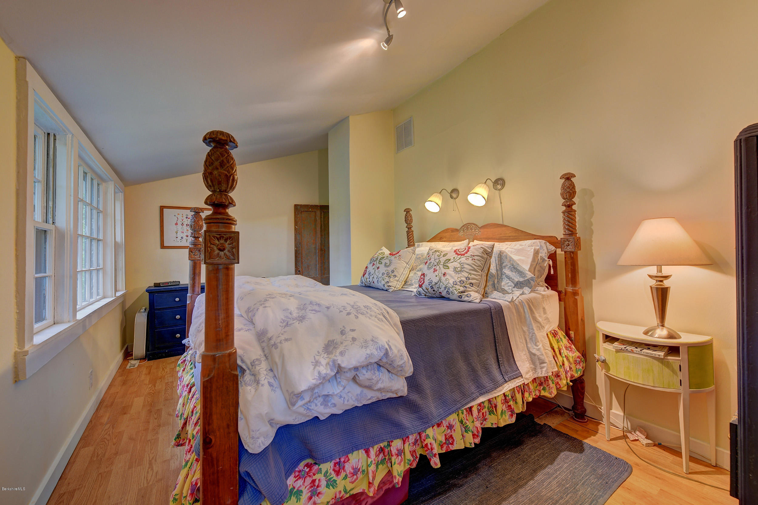 222 Main Road Monterey, MA 01245 - Photo 11 of 17 a bed room with a bed and a chandelier