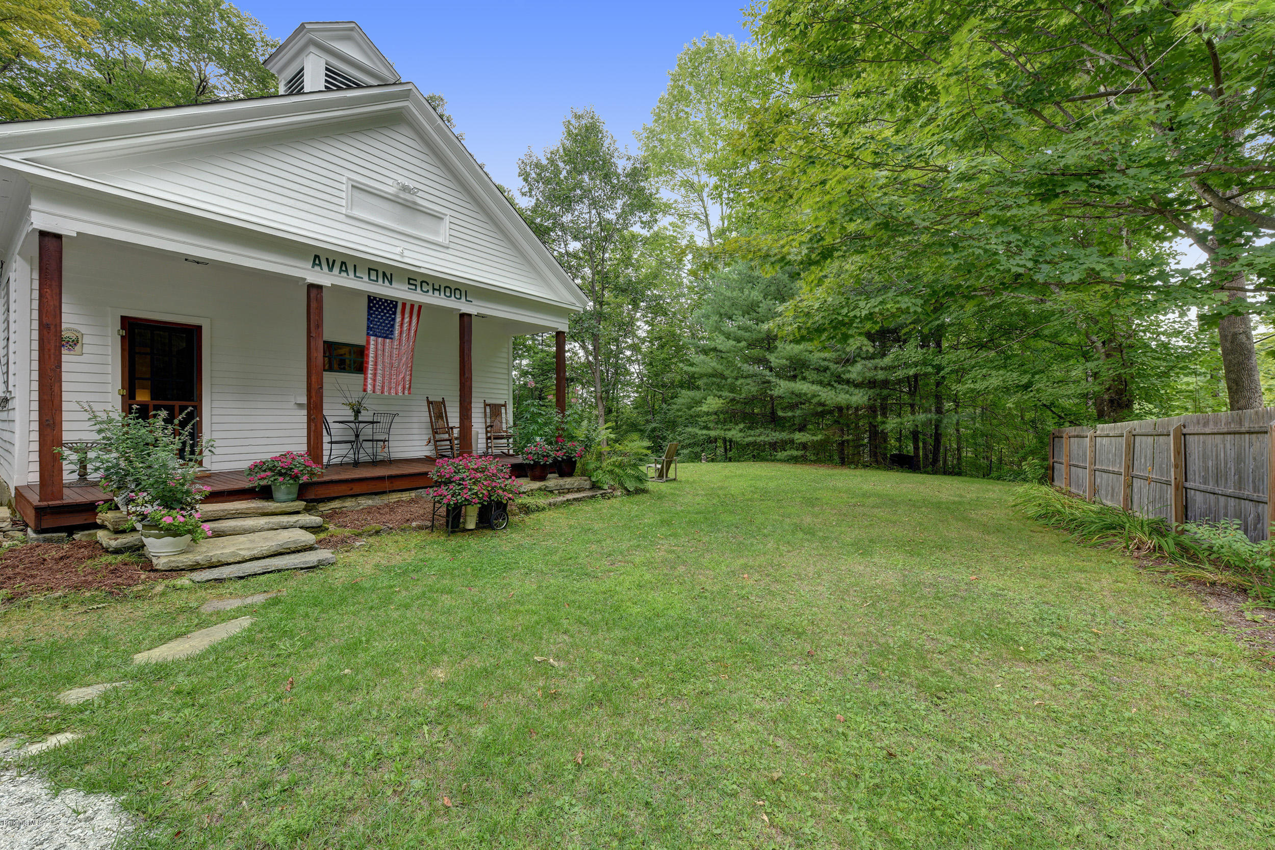 222 Main Road Monterey, MA 01245 - Photo 4 of 17 a view of a house with backyard sitting area and garden