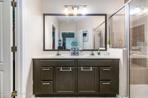 a bathroom with a shower sink and mirror