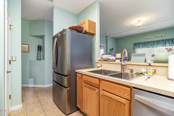 a kitchen with stainless steel appliances granite countertop a sink and cabinets with wooden floor