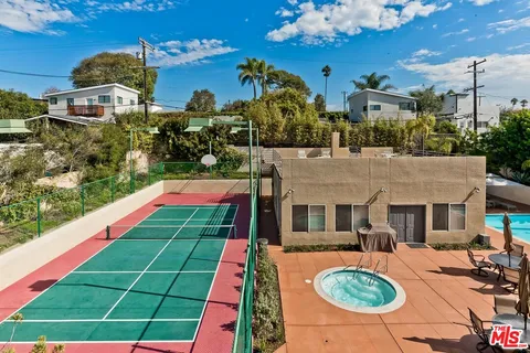 a front view of house with yard swimming pool and outdoor seating