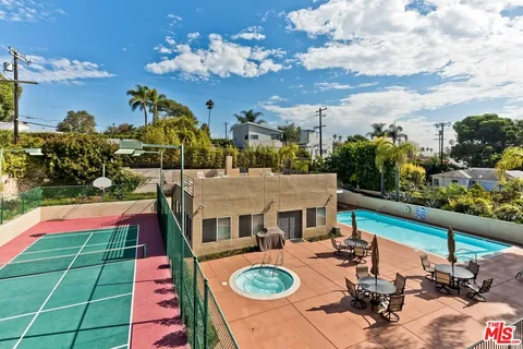 a view of a balcony with dining table and chairs