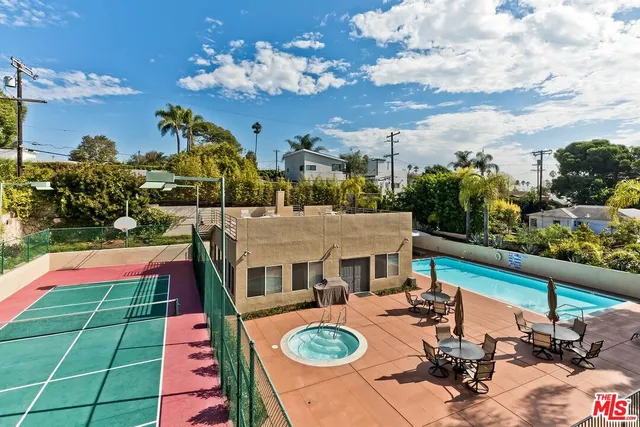 a view of a balcony with dining table and chairs