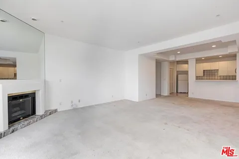 a view of an empty room with a fireplace