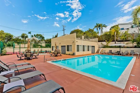 a view of a swimming pool with outdoor seating