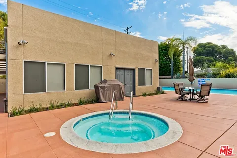 a swimming pool with outdoor seating