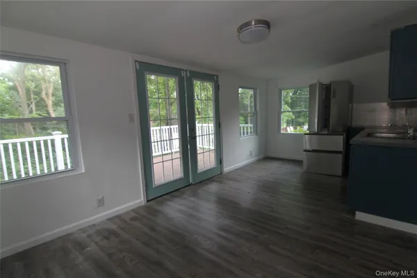 a room with wooden floors and window