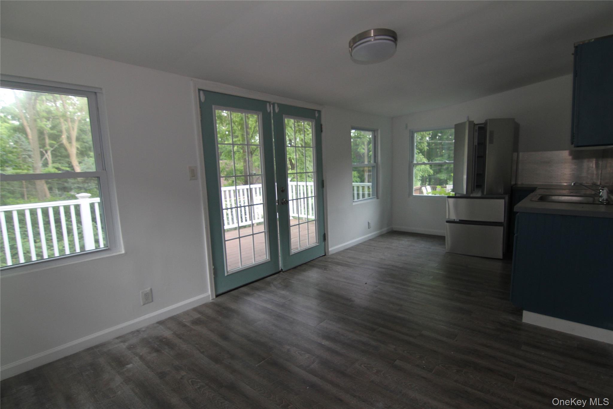 71 Miller Road, Unit 13 Hopewell Junction, NY 12533 - Photo 11 of 28 a view of an empty room with wooden floor and a window