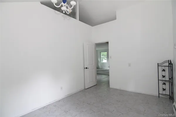 a view of a hallway with wooden shelves