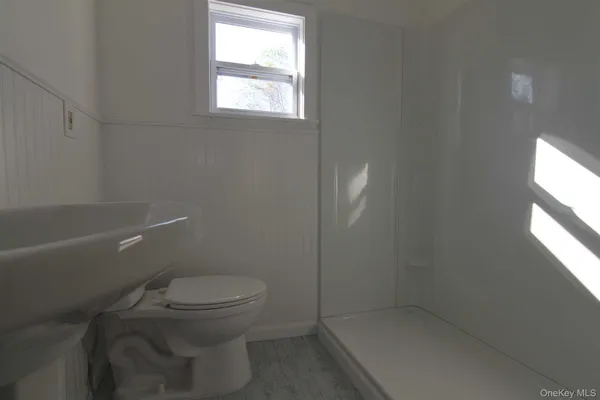 a view of a room with wooden floor and windows