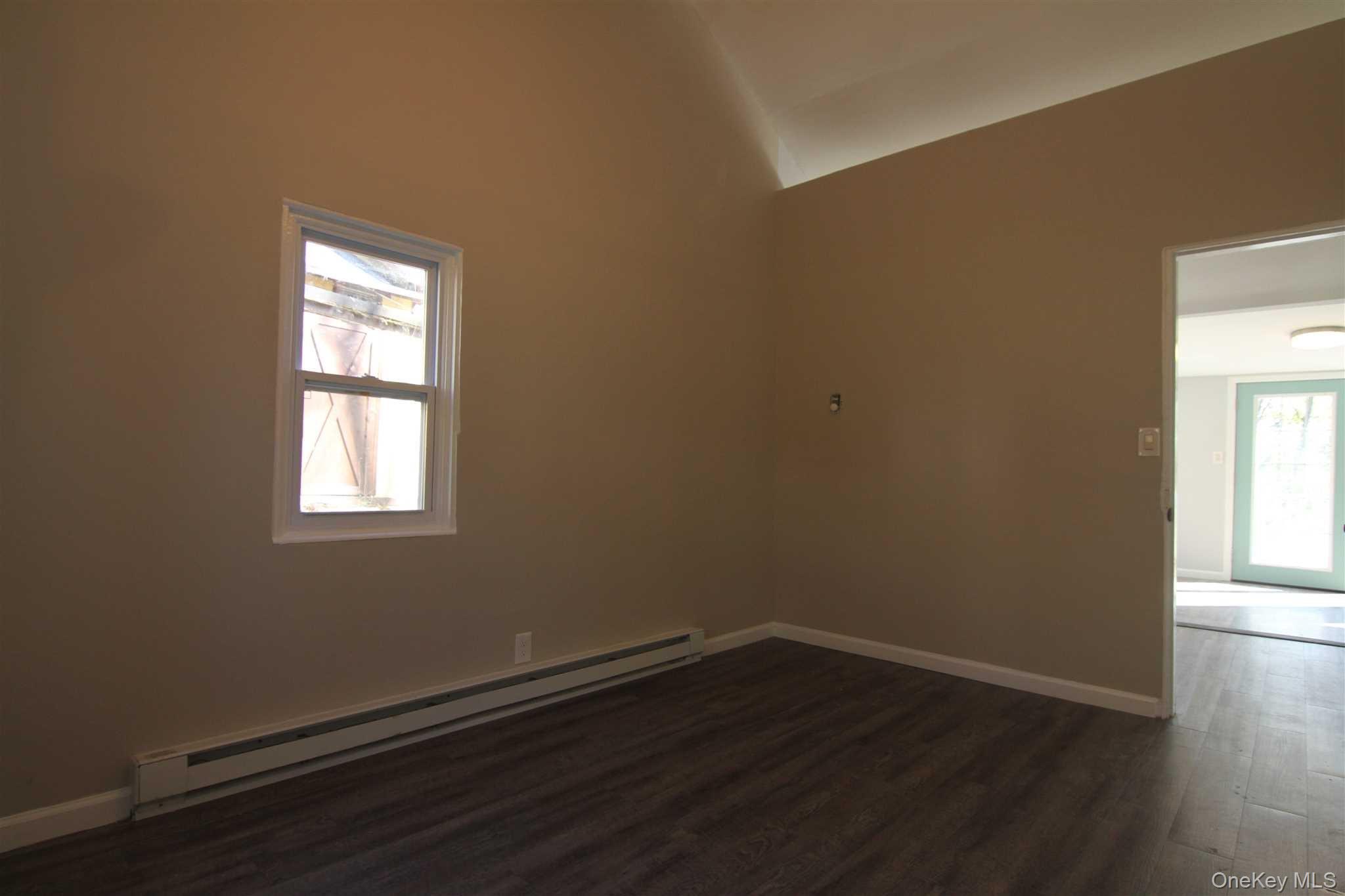 71 Miller Road, Unit 13 Hopewell Junction, NY 12533 - Photo 22 of 28 an empty room with wooden floor and windows