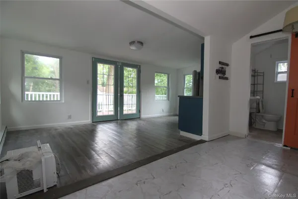 an empty room with windows and entrance