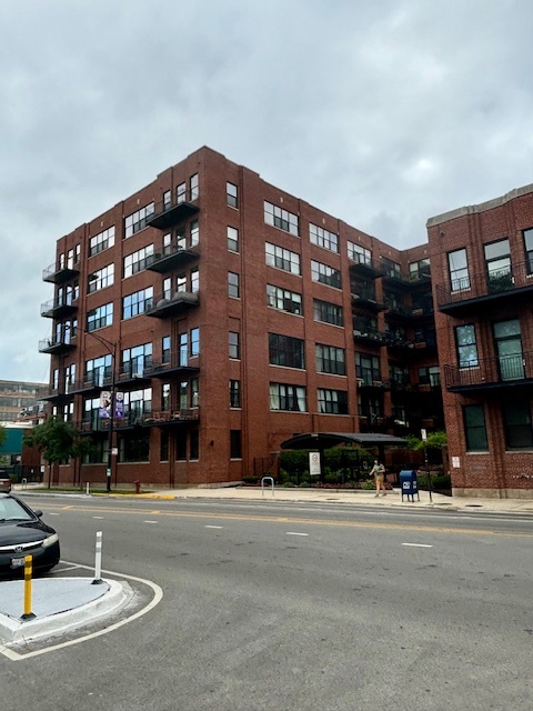 2323 West Pershing Road, Unit 222 Chicago, IL 60609 - Photo 2 of 16 a building view couches and a building in the background