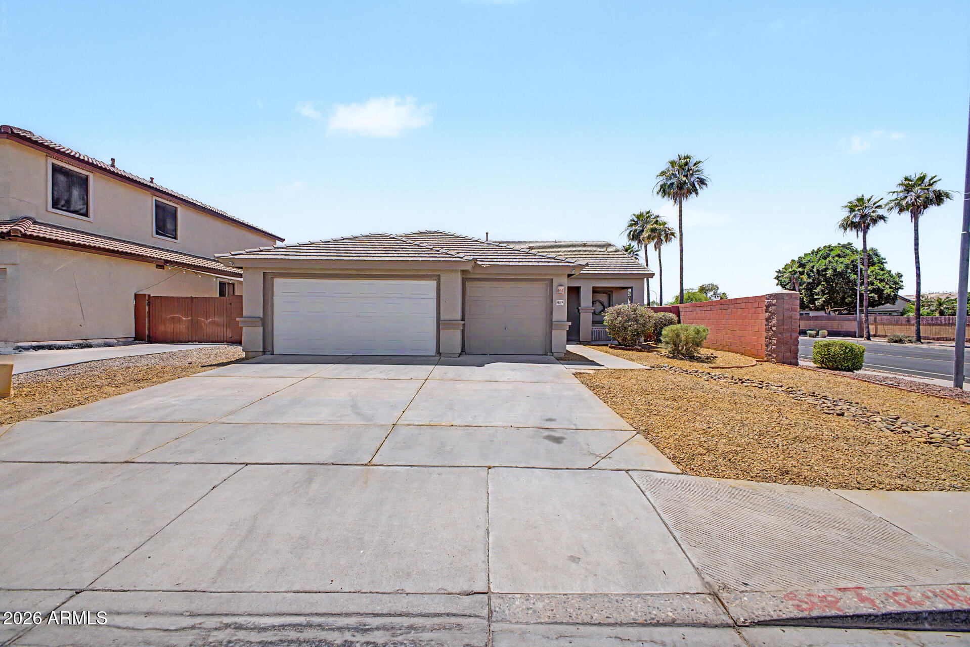 11199 West Monte Vista Road Avondale, AZ 85392 - Photo 1 of 36 a front view of a house with a yard and potted plants