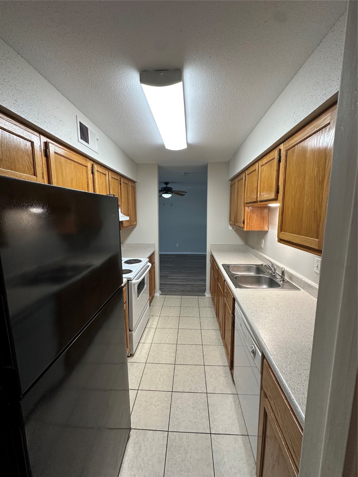 6500 Sands Point Drive, Unit 404 Houston, TX 77074 - Photo 12 of 27 a kitchen with a stove a sink and a refrigerator
