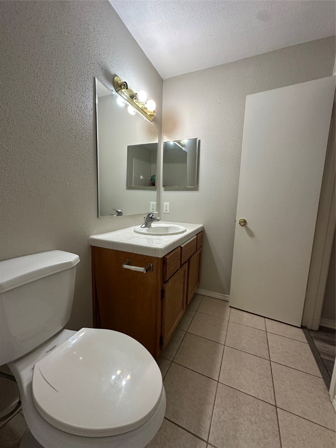6500 Sands Point Drive, Unit 404 Houston, TX 77074 - Photo 17 of 27 a bathroom with a sink a toilet and mirror