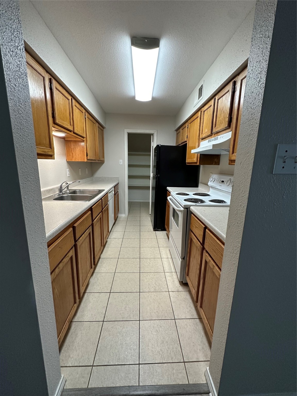 6500 Sands Point Drive, Unit 404 Houston, TX 77074 - Photo 7 of 27 a kitchen with stainless steel appliances granite countertop a stove a sink and a refrigerator