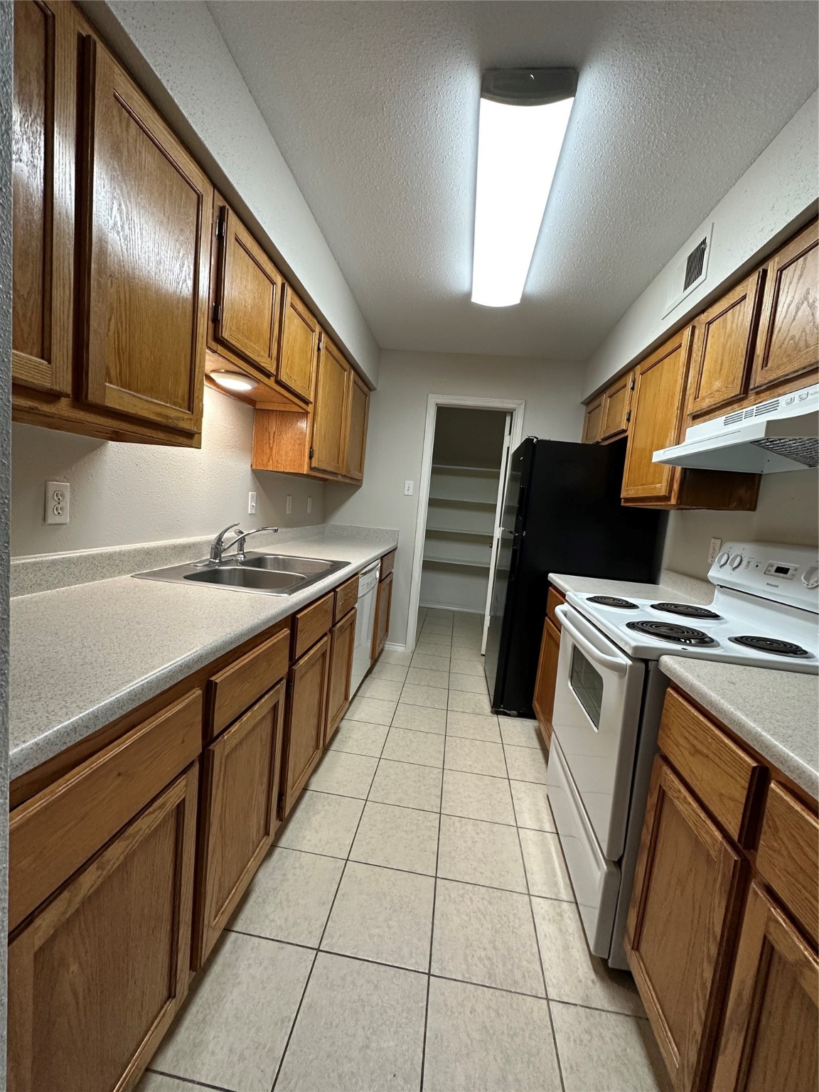 6500 Sands Point Drive, Unit 404 Houston, TX 77074 - Photo 10 of 27 a kitchen with stainless steel appliances granite countertop a stove a sink and a microwave