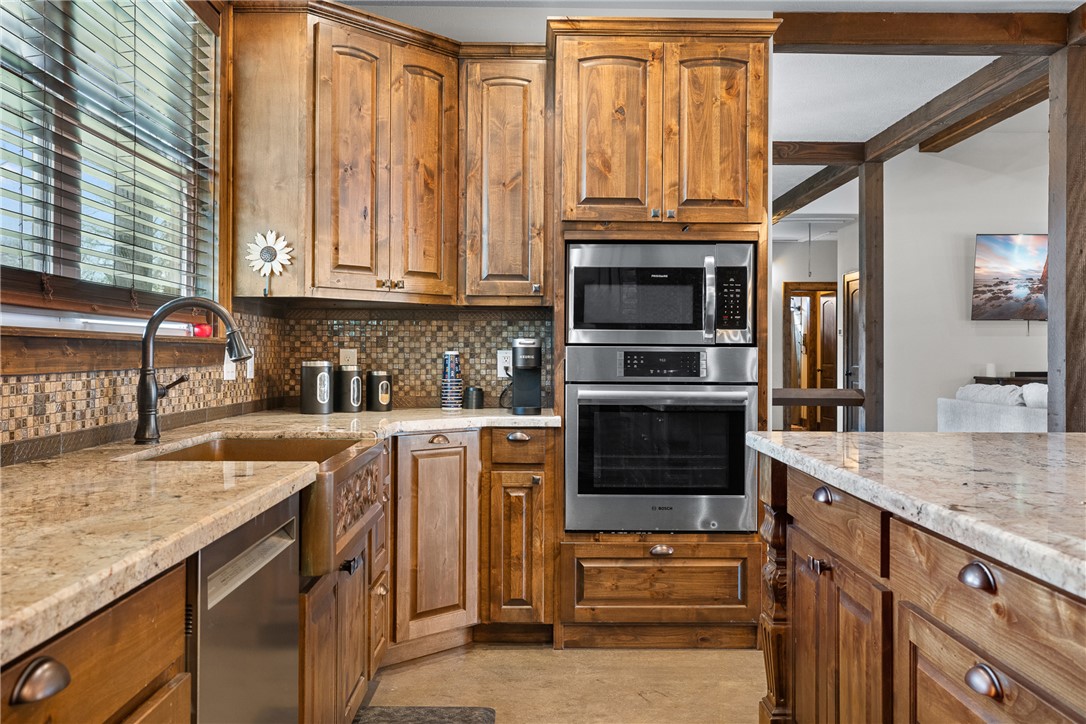 7440 Fm 39 Road South North Zulch, TX 77872 - Photo 18 of 50 a kitchen with stainless steel appliances granite countertop a stove and a sink