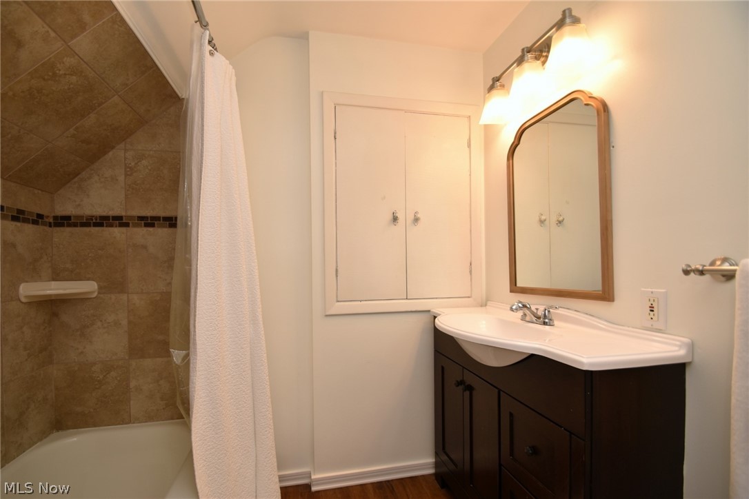1174 Haverston Road Cleveland, OH 44124 - Photo 19 of 21 Bathroom featuring shower / tub combo, wood-type flooring, and vanity