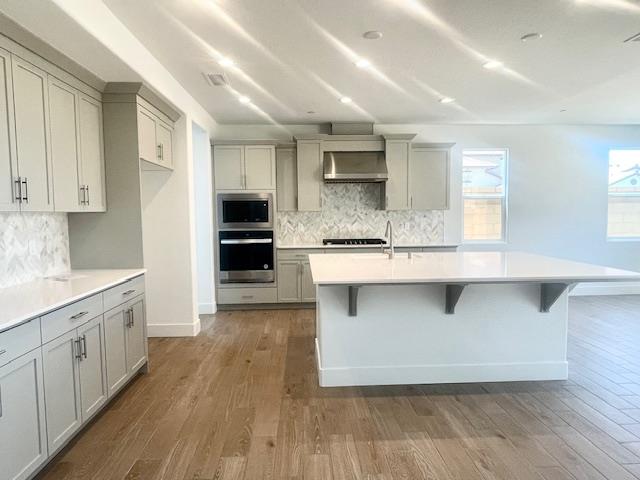 846 Huckleberry Road Madera, CA 93636 - Photo 5 of 12 a large kitchen with stainless steel appliances a large counter top a stove a refrigerator and a sink