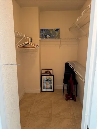a view of storage and utility room with two washing machine