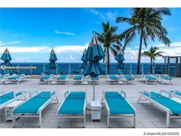 a view of a swimming pool and chairs