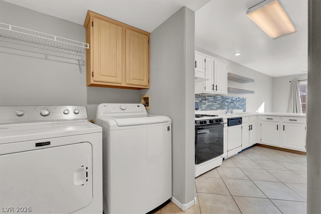 10148 Tree Bark Street Las Vegas, NV 89183 - Photo 14 of 37 Functional utility space with dedicated laundry appliances complements the adjacent efficient kitchen.