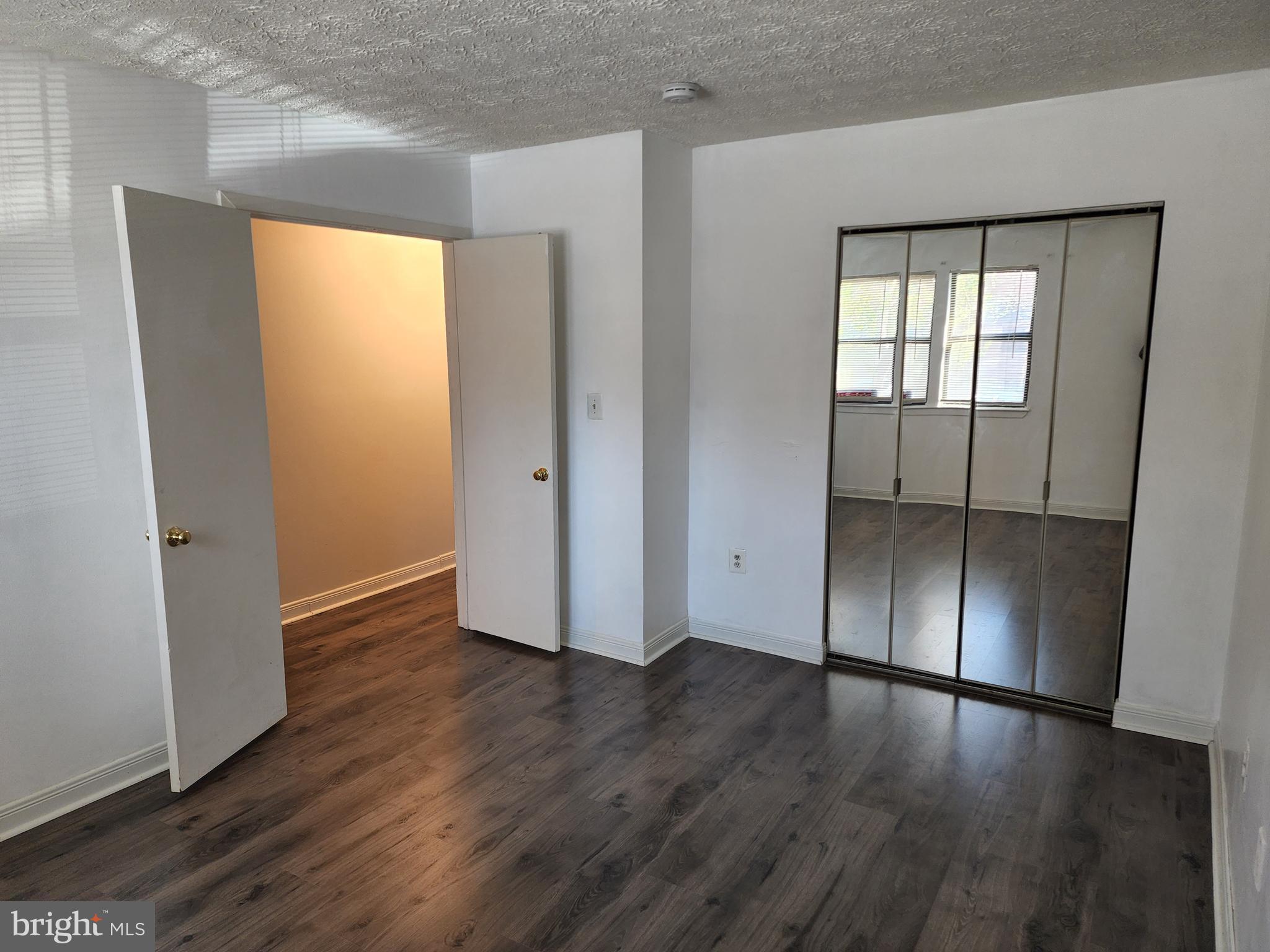 7603 Weather Worn Way, Unit F Columbia, MD 21046 - Photo 11 of 17 an empty room with wooden floor and door